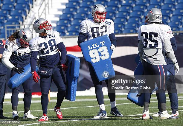 From left: New England Patriots James White laughs as he, Matt Lengel, and Tyler Gaffney prepare for a drill during practice at Gillette Stadium in...