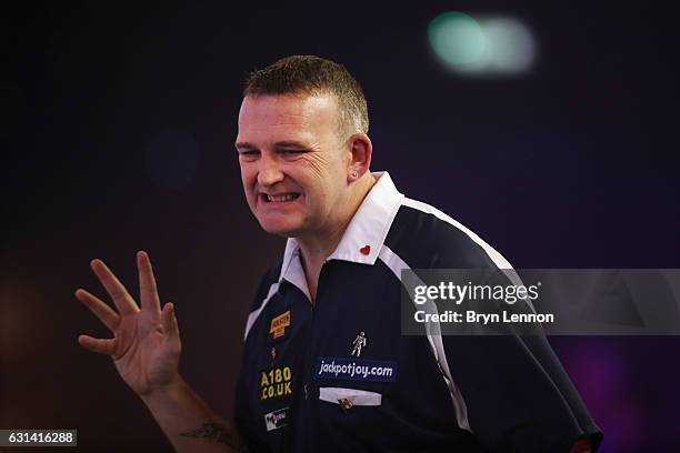 Mark McGeeney of Great Britain reacts during his first round match on day four of the BDO Lakeside World Professional Darts Championships on January...