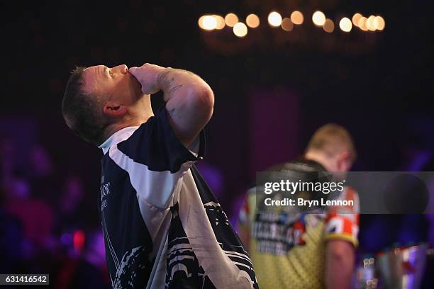 Mark McGeeney of Great Britain celebrates winning his first round match on day four of the BDO Lakeside World Professional Darts Championships on...