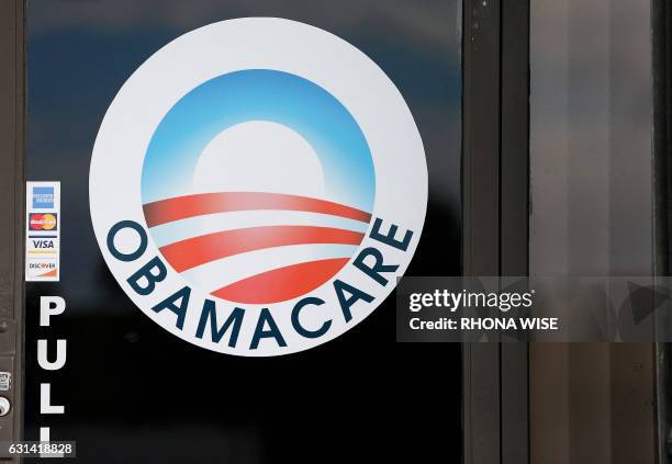 An Obamacare logo is shown on the door of the UniVista Insurance agency in Miami, Florida on January 10, 2017. As President-elect Donald Trump's...