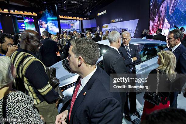 Vice President Joseph "Joe" Biden, center right, stands next to a General Motors Co. Bolt EV with Mark Reuss, executive vice president of global...