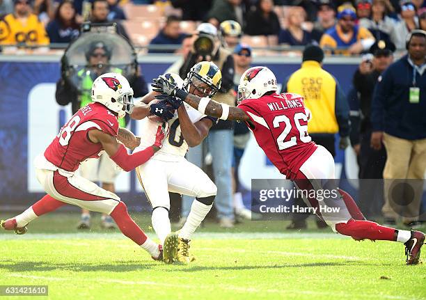 Pharoh Cooper of the Los Angeles Rams is tackled by Justin Bethel and Brandon Williams of the Arizona Cardinals at Los Angeles Memorial Coliseum on...