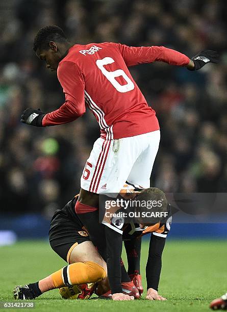 Manchester United's French midfielder Paul Pogba vies with Hull City's English defender Josh Tymon during the EFL Cup semi-final football match...