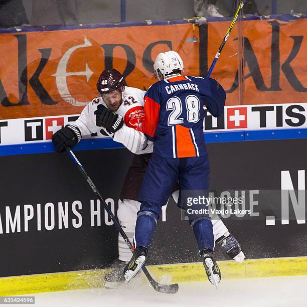 Nils Carnback of Vaxjo Lakers checks Michal Barinka of Sparta Prague during the Champions Hockey League Semi Final match between Vaxjo Lakers and...