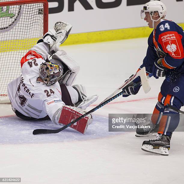 Olli Palola of Vaxjo Lakers challenges Tomas Popperle of Sparta Prague during the Champions Hockey League Semi Final match between Vaxjo Lakers and...