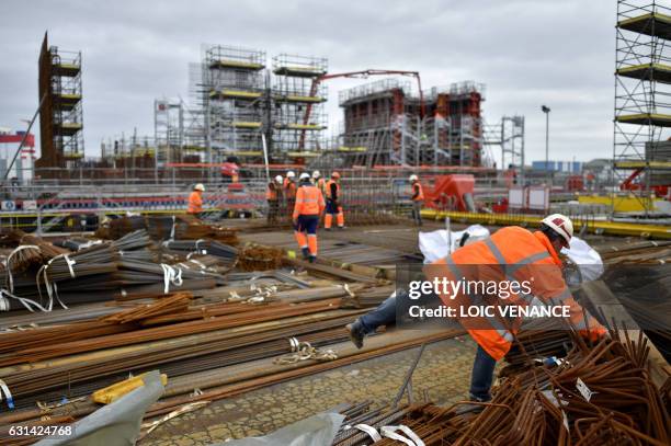 Workers build a concrete floating structure in order to support an offshore floating wind turbine, on January 10, 2017 in Saint-Nazaire, western...