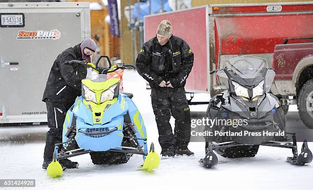 To R, Samuel and Robert Atkinson of Windham get ready to head out on the trails in the village of Oquossoc in the town of Rangeley Wednesday,...