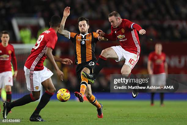 Wayne Rooney of Manchester United in action with Ryan Mason of Hull City during the EFL Cup Semi-Final first leg match between Manchester United and...