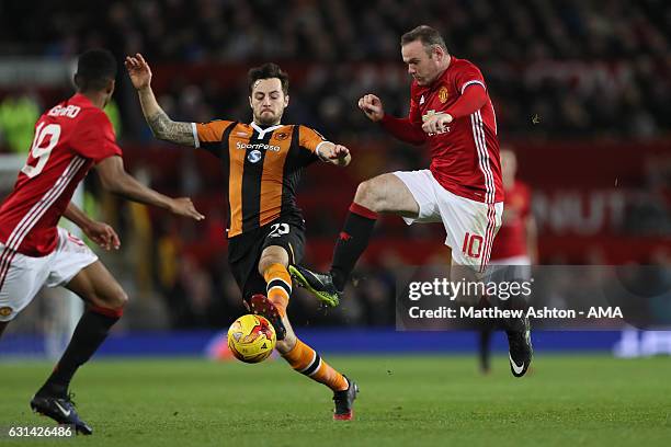 Wayne Rooney of Manchester United in action with Ryan Mason of Hull City during the EFL Cup Semi-Final first leg match between Manchester United and...