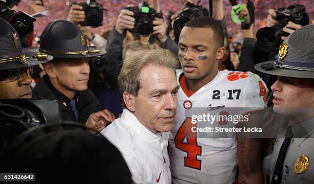 Head coach Nick Saban of the Alabama Crimson Tide talks with Deshaun Watson of the Clemson Tigers after the Tigers defeated the Crimson Tide 35-31 in...