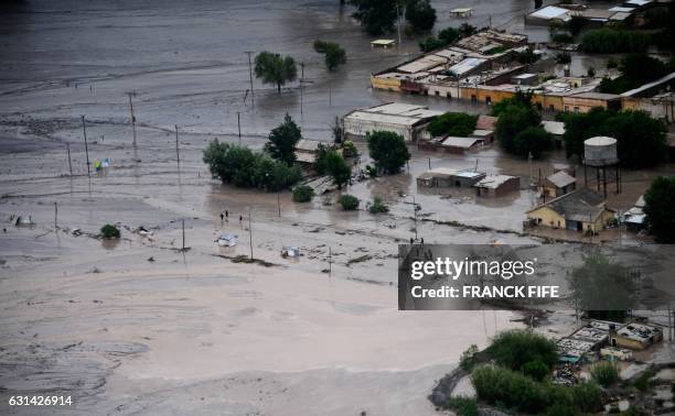 Picture taken on January 10, 2017 shows a road covered in mud following a landslide caused by a storm in the village of Volcan, during the Stage 8 of...