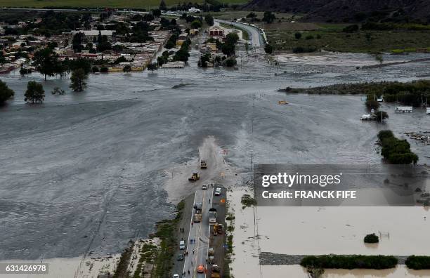 Picture taken on January 10, 2017 shows a road covered in mud following a landslide caused by a storm in the village of Volcan, during the Stage 8 of...