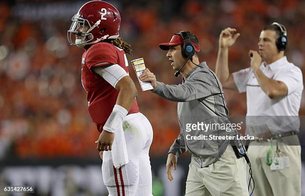 Offensive coordinator Steve Sarkisian of the Alabama Crimson Tide talks with quarterback Jalen Hurts during the second half of the 2017 College...