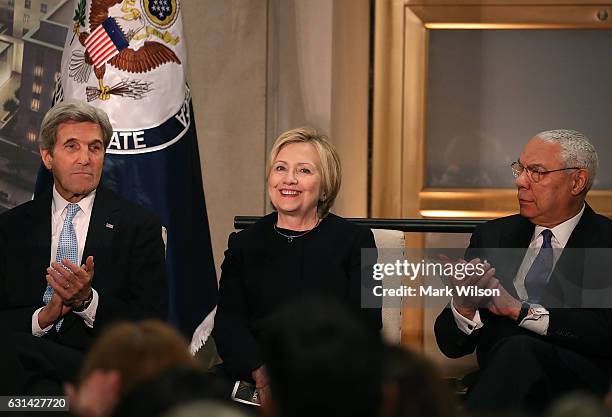 Former Secretary of State Hillary Clinton is applauded by Secretary of State John Kerry , and former Secretary of State, Colin Powell, during a...