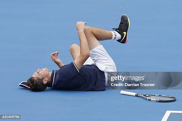 Andrew Whittington of Australia rolls his ankle in his match against Mikhail Youzhny of Russia during day two of the 2017 Priceline Pharmacy Classic...