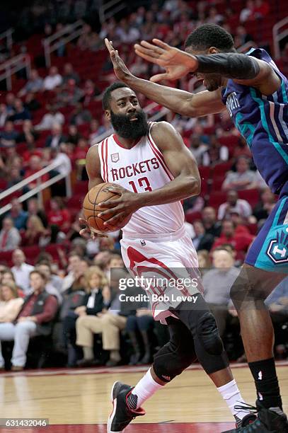 James Harden of the Houston Rockets drives to the basket as Roy Hibbert of the Charlotte Hornets defends at Toyota Center on January 10, 2017 in...