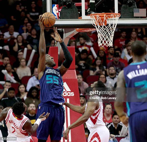 Roy Hibbert of the Charlotte Hornets shoots over James Harden of the Houston Rockets as Patrick Beverley looks on at Toyota Center on January 10,...