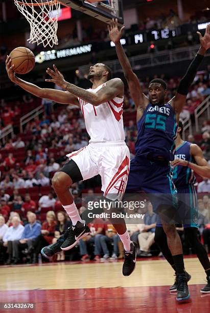 Trevor Ariza of the Houston Rockets drives baseline past Roy Hibbert of the Charlotte Hornets for a reverse layup at Toyota Center on January 10,...