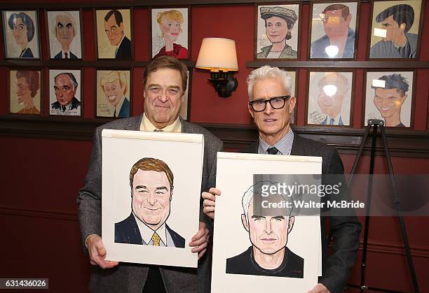 John Goodman and John Slattery pose with their newly unveiled caricatures at Sardi's on January 10, 2017 in New York City.