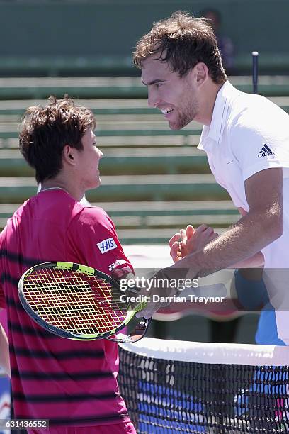 Yoshihito Nishioka of Japan and Jerzy Janowicz of Poland shake hand after their match on day two of the 2017 Priceline Pharmacy Classic at Kooyong...