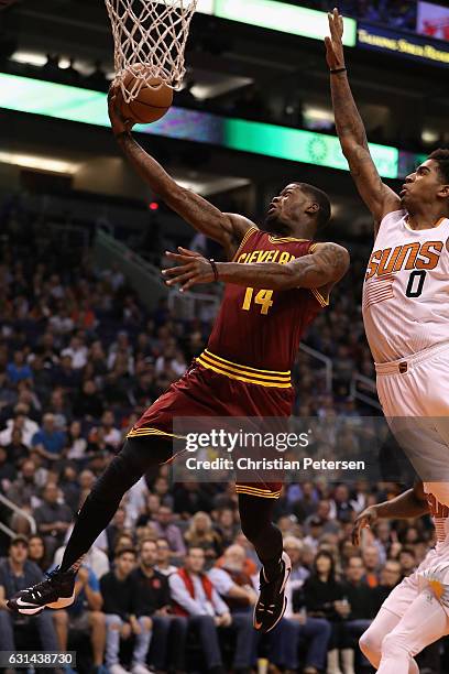 DeAndre Liggins of the Cleveland Cavaliers lays up a shot against the Phoenix Suns during the first half of the NBA game at Talking Stick Resort...