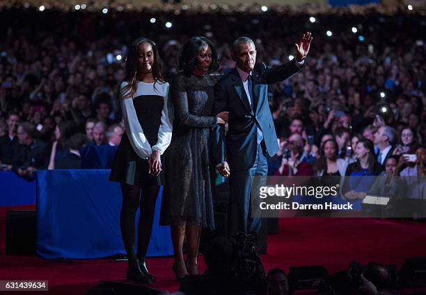 President Barack Obama, first lady Michelle Obama and daughter Malia Obama wave goodbye to supporters after Obama's farewell address at McCormick...