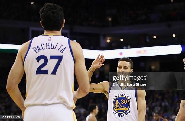 Stephen Curry of the Golden State Warriors congratulates Zaza Pachulia during their game against the Miami Heat at ORACLE Arena on January 10, 2017...