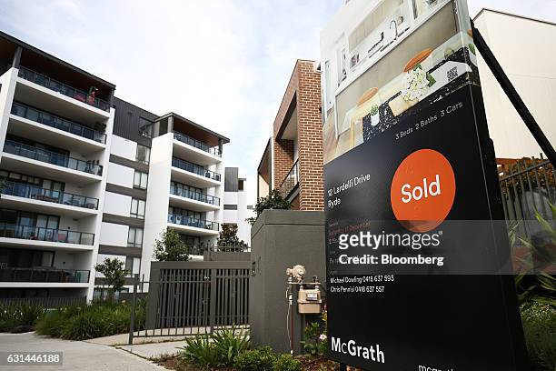 Real estate billboard with a "Sold" sign stands in front of newly constructed houses in the suburb of Putney Hill in Sydney, Australia, on Sunday,...