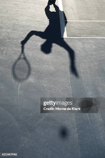 The shadow Mike Bryan of the USA is visible as he serves during the 2017 World Tennis Challenge at Memorial Drive on January 11, 2017 in Adelaide,...