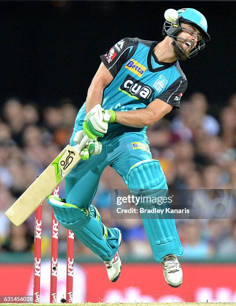 Alex Ross of the Heat attempts to move out of the way of a bouncer bowled by Mitchell Johnson of the Scorchers during the Big Bash League match...