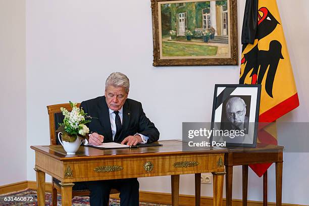 German President Joachim Gauck writes an entry in the book of condolence for the family of Former German President Roman Herzog at Bellevue Palace on...