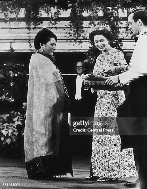 Queen Elizabeth II creates the Maori Queen, Te Arikinui Te Atairangikaahu as a Dame Commander of the British Empire in an investiture ceremony at...