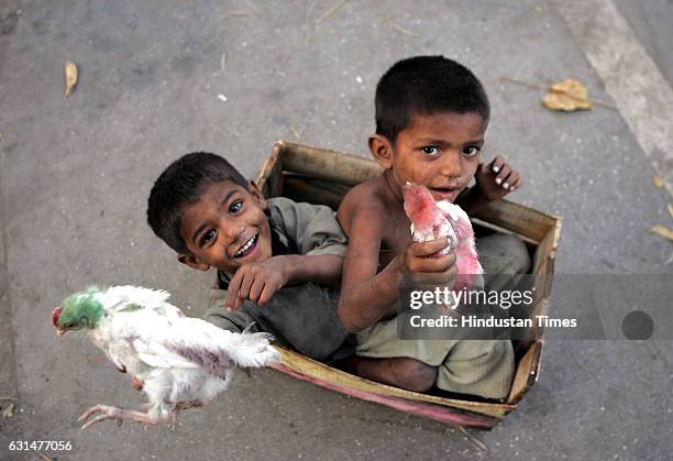 Street Children enjoying with birds going by wheel trolly at Senapati Bapat Marg in Mumbai on Monday.