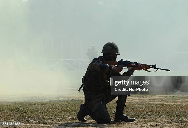 An Indian army commando takes part in a surgical strike mock operation , on the second day of the 'Know your army exhibition' in Allahabad on January...