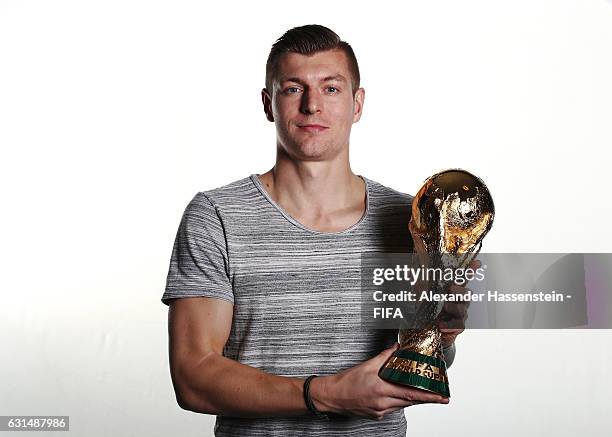Toni Kroos of Germany and Real Madrid poses with the FIFA World Cup trophy prior to The Best FIFA Football Awards at Kameha Zurich Hotel on January...