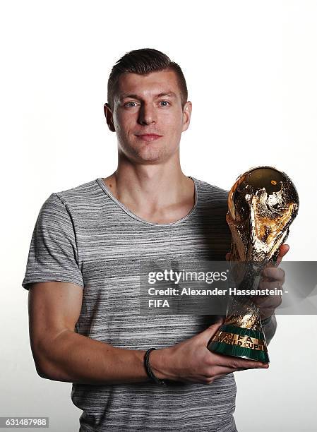 Toni Kroos of Germany and Real Madrid poses with the FIFA World Cup trophy prior to The Best FIFA Football Awards at Kameha Zurich Hotel on January...