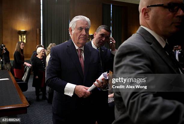 Former ExxonMobil CEO Rex Tillerson, U.S. President-elect Donald Trump's nominee for Secretary of State, leaves the room for a lunch break during his...