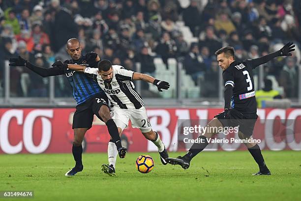 Tomas Rincon of FC Juventus is challenged by Rafael Toloi and Abdoulay Konko of Atalanta BC during the TIM Cup match between FC Juventus and Atalanta...