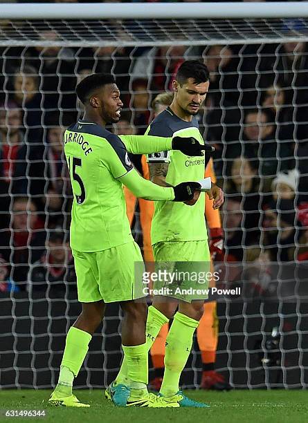 Daniel Sturridge of Liverpool receives a piece of paper from Jurgen Klopp Manager with instructions for the team during the EFL Cup Semi-Final match...