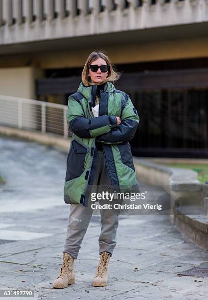 Chiara Capitani is wearing a down feather jacket, jogger pants, boots, sunglasses on January 11, 2017 in Florence, Italy.