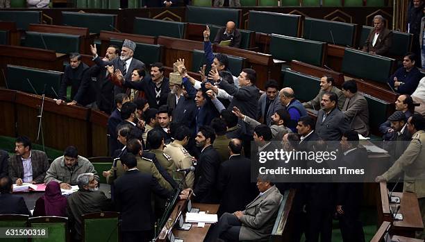 Opposition National Conference and Congress MLA's shouting slogans in Legislative Assembly during their protest over various issues, on January 11,...