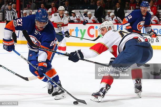 Anders Lee of the New York Islanders battles for the puck against Jakub Kindl of the Florida Panthers at the Barclays Center on January 11, 2017 in...