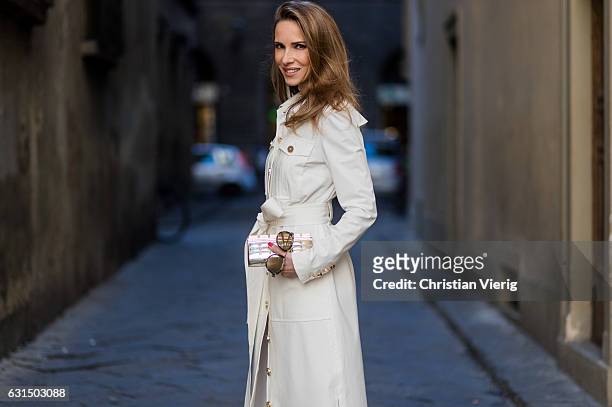 German fashion blogger and model Alexandra Lapp is wearing trenchcoat dress in white with golden buttons waisted with a belt from Talbot Runhof,...