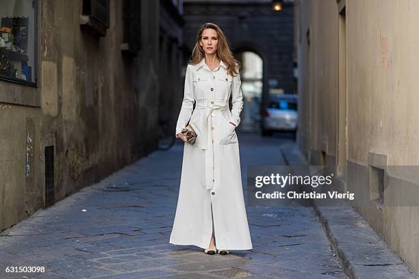 German fashion blogger and model Alexandra Lapp is wearing trenchcoat dress in white with golden buttons waisted with a belt from Talbot Runhof,...