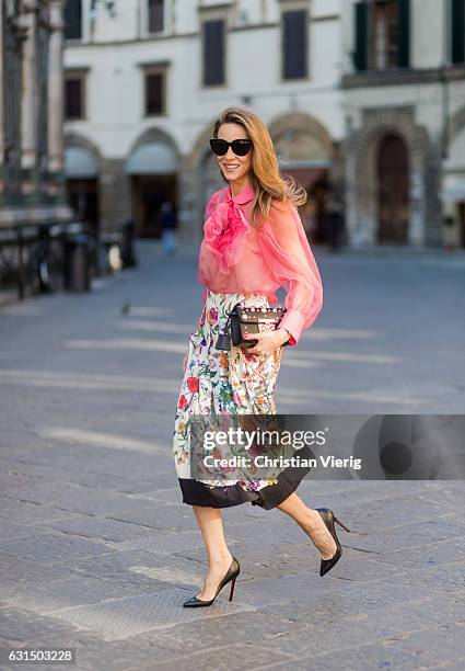 German fashion blogger and model Alexandra Lapp is wearing a black Padlock shoulder bag by Gucci , a pink blouse by Gucci, pleated Flora snake, silk...