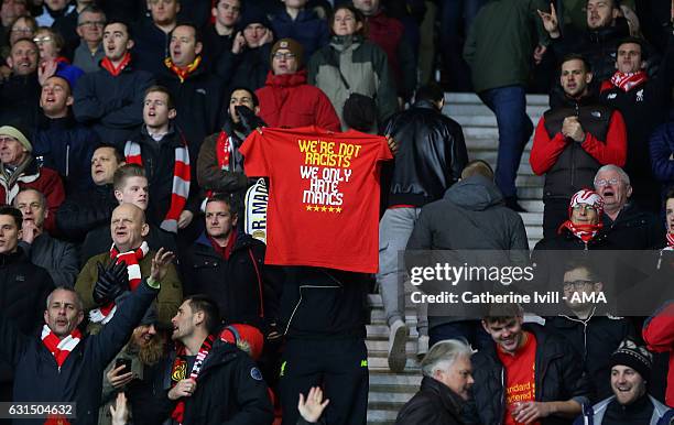 Liverpool fan holds up a t-shirt saying, we're not racists we only hate mancs during the EFL Cup semi-final first leg match between Southampton and...