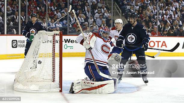 Shot from Mark Scheifele of the Winnipeg Jets beats Al Montoya of the Montreal Canadiens during NHL action on January 11, 2017 at the MTS Centre in...