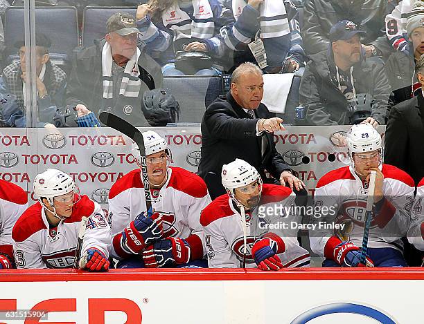 Head Coach Michel Therrien of the Montreal Canadiens points from the bench during second period action against the Winnipeg Jets at the MTS Centre on...