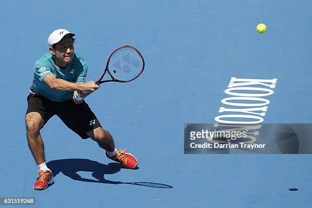 Yoshihito Nishioka of Japan plays a backhand shot in his match against Karen Khachanov of Russia during day three of the 2017 Priceline Pharmacy...