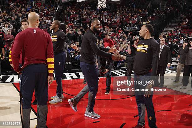 LeBron James and Jordan McRae of the Cleveland Cavaliers shake hands before the game against the Portland Trail Blazers on January 11, 2017 at the...